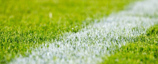 Sportplatzlinien mit hochwertiger Rasenmarkierungsfarbe auf einem gepflegten Fu&szlig;ballfeld f&uuml;r professionelle Anlagenausstattung