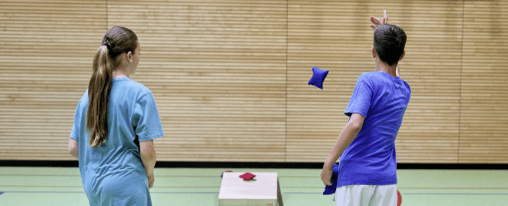 Cornhole online kaufen: Freizeitspiele und Wurfspiele im Kübler Sport Onlineshop Personen spielen Cornhole im Freien mit Säckchen und Holzbrettern – beliebtes Wurfspiel für Freizeit, Familie und Freunde