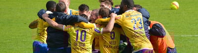 Fußballmannschaft jubelt gemeinsam auf dem Sportplatz