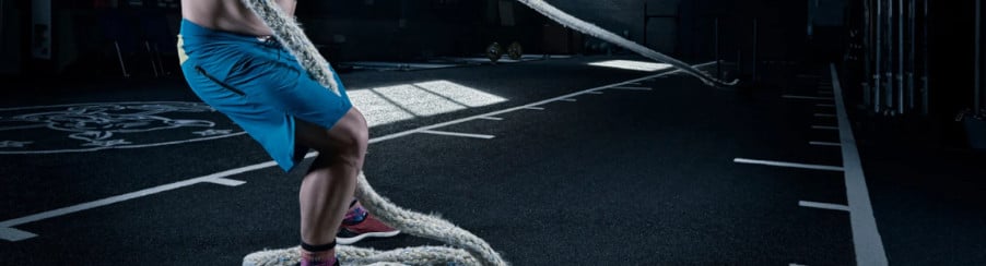 Mann trainiert auf einem Sportboden im Fitnessstudio